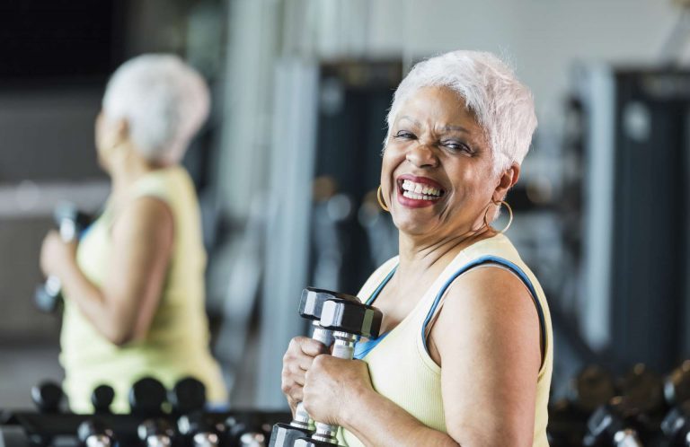 Senior woman holding gym weights