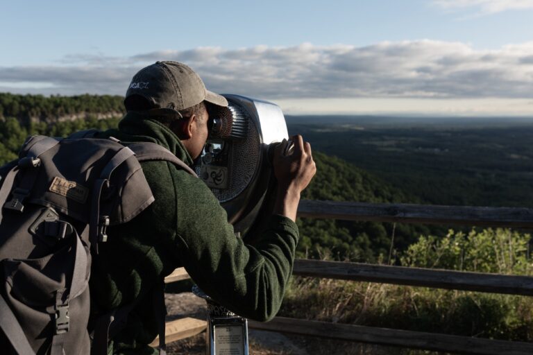 Photo of man looking through a spotting scope