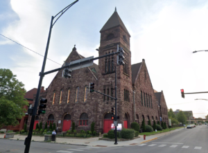 The Metropolitan Apostolic Community Church is brightly lit in sunlight on the corner of S. King Drive and E. 41 St.